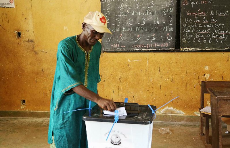 A man casts his vote during presidential elections in the Bambeto neighborhood of Conakry, Guinea, on Sunday.