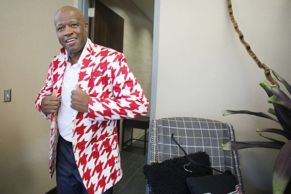 University of Arkansas Razorback head basketball coach Mike Anderson displays a gift from professional golfer John Daly, a jacket, in the Basketball Performance Center Monday, October 12, 2015 on the campus of the University of Arkansas in Fayetteville.