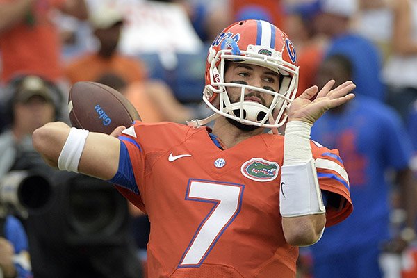 In this Oct. 3, 2015, file photo, Florida quarterback Will Grier warms up before an NCAA college football game against Mississippi in Gainesville, Fla. (AP Photo/Phelan M. Ebenhack, File)
