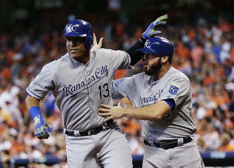 Kansas City’s Salvador Perez (left) celebrates with teammate Mike Moustakas during Game 4 of their American League division series against Houston on Monday. The Royals trailed 6-2 in the eighth inning but scored the game’s final seven runs to pull out a 9-6 victory and force a deciding game Wednesday.
