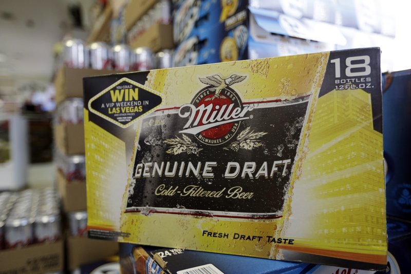 FILE - In this Monday, Jan. 28, 2013 file photo, Miller Genuine Draft beer is for sale on a shelf in the aisles of Elite Beverages in Indianapolis. British-based brewer SABMiller accepted in principle a $106 billion takeover offer from Anheuser Busch InBev on Tuesday, Oct. 13, 2015 that will create the world's biggest beer company and bring together top U.S. brands Budweiser and Miller Genuine Draft. (AP Photo/Michael Conroy, File)
