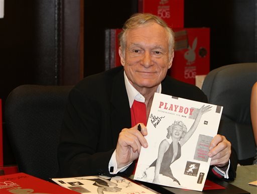 In this Nov. 15, 2007 photo, Hugh Hefner smiles while signing copies of the Playboy calendar and "Playboy Cover To Cover: The 50's" DVD box set in Los Angeles.