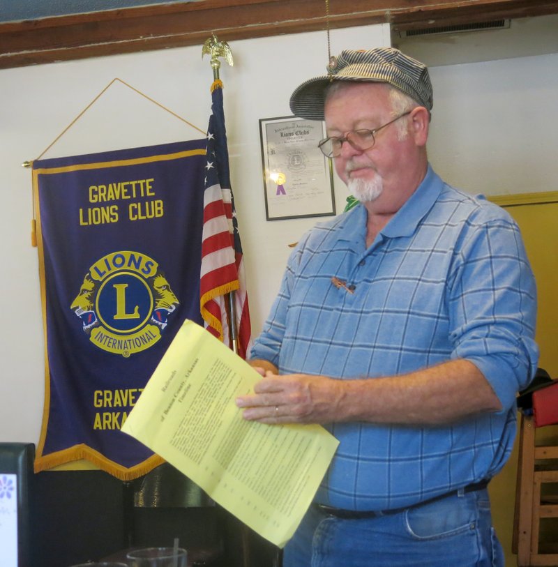Photo by Susan Holland Al Blair, a member of the Gravette Historical Museum commission, referred to a Railroads of Benton County timeline when he spoke to the Gravette Lions Club at its Oct. 6 meeting. Blair told the Lions about the history of the railroads in and around Gravette and about his work in restoring the model train layout and Old Town Park diorama at the museum.