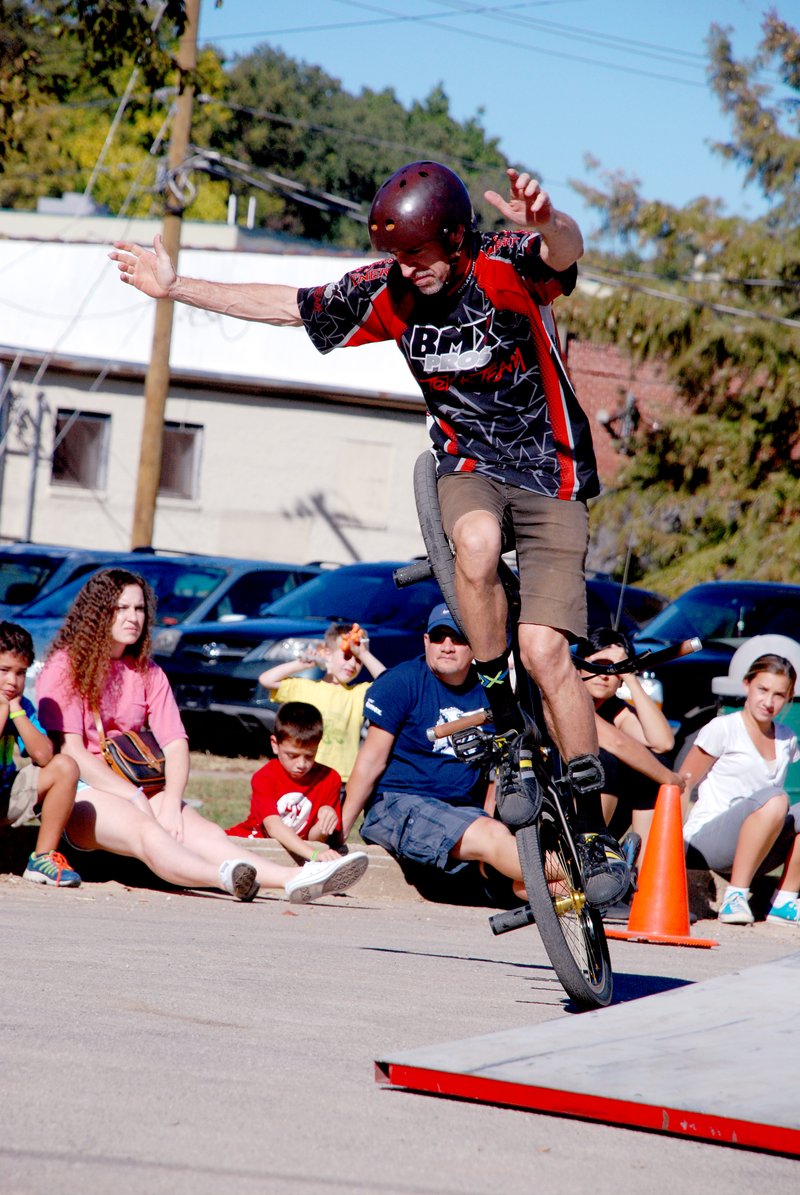 Jeff Della Rosa/Special to The Herald-Leader Scott Ditchfield, pro BMX stuntman, holds up his hands while riding his bicycle with one foot on a peg and the other on the rear tire. Ditchfield, who was featured in America&#8217;s Got Talent last year, performed his tricks on the ground.