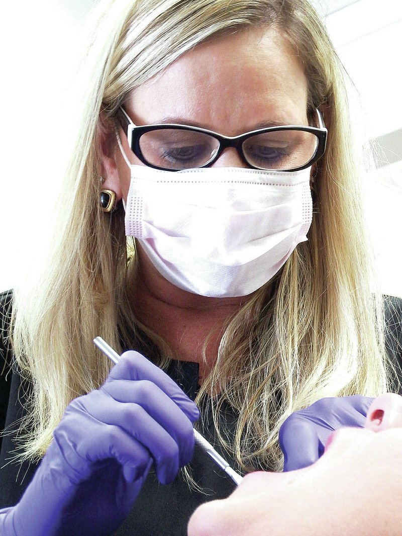 TIMES photographs Annette Beard Dr. Crystal Norton enjoys cosmetic dentistry.