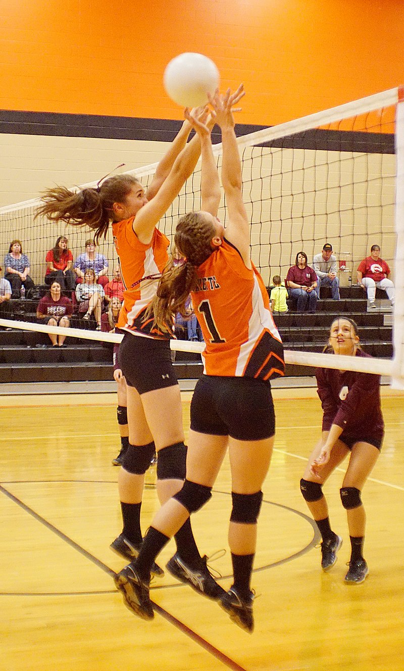 Misa Satchel and Destiny Laymon attempt to block a kill attempt by the visiting Huntsville volleyball team on Thursday.