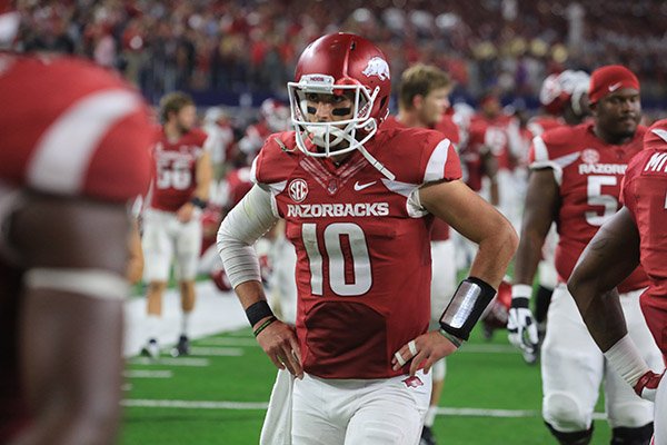 Arkansas quarterback Brandon Allen walks off the field following a 28-21 overtime loss to Texas A&M on Saturday, Sept. 26, 2015, at AT&T Stadium in Arlington, Texas. 