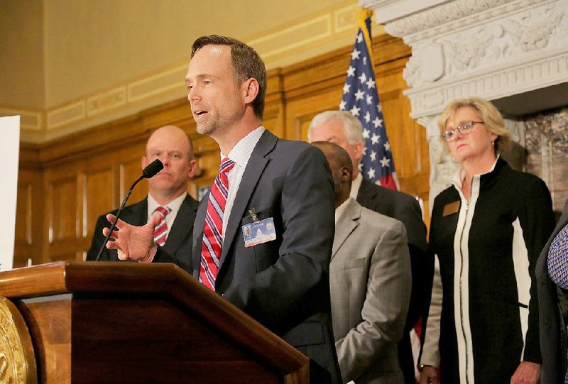 Arkansas Surgeon General Dr. Greg Bledsoe talks about the 10-year Healthy Active Arkansas plan Wednesday at the state Capitol in Little Rock.