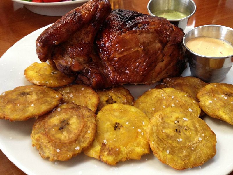 Pollo a la Brasa (Peruvian-style rotisserie chicken) at Lulu’s Rotisserie & Grill comes in quarter-, half- and whole chicken servings; here it’s served with Aji Amarillo and Lulu’s Green Sauce, plus a side of fried plantains. 