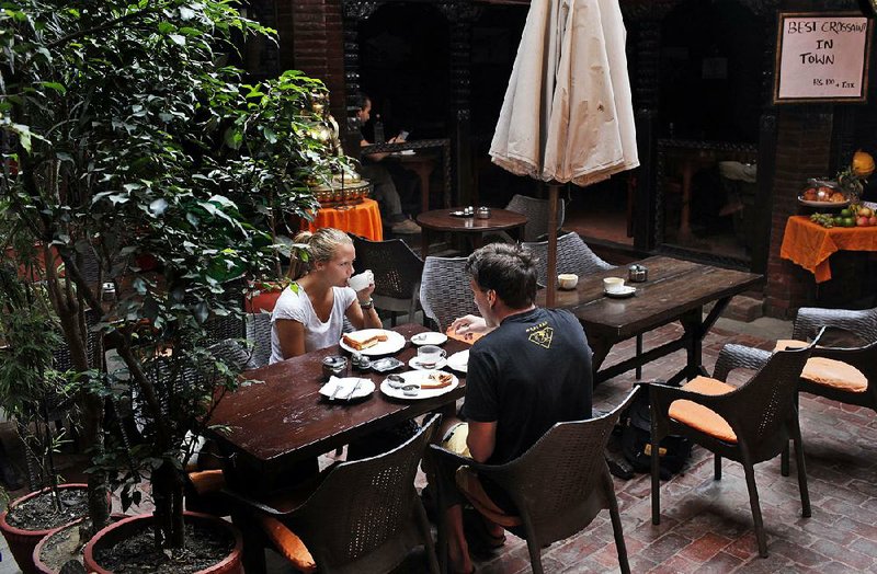 Norwegian couple Tom Omdal and Elise Skogheim eat breakfast earlier this month at the popular New Orleans Restaurant in Thamel, the tourist hub in Kathmandu, Nepal.

