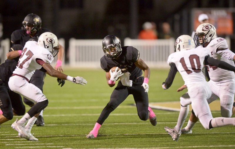 Kam'ron Mays-Hunt, Bentonville wide receiver, evades Springdale defenders in the second quarter on Friday Oct. 16, 2015 during the game in Bentonville's Tiger Stadium.