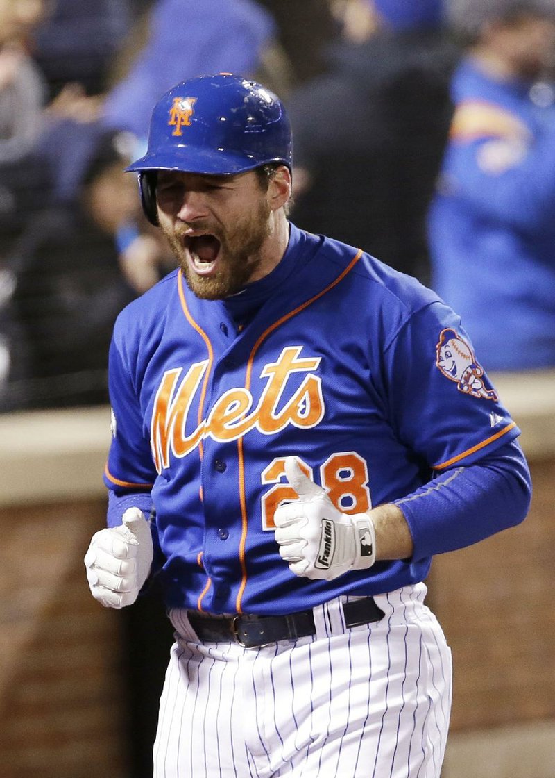 New York second baseman Daniel Murphy reacts after hitting a home in the first inning to lift the Mets to a 4-2 victory over Chicago in Game 1 of the National League Championship Series.
