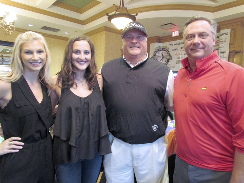 NWA Democrat-Gazette/APRIL ROBERTSON Julie Drew, Jordan Smith, Scott Smith and Chris Harlin pause for a photo during the Ultimate Tailgate Sports Auction.