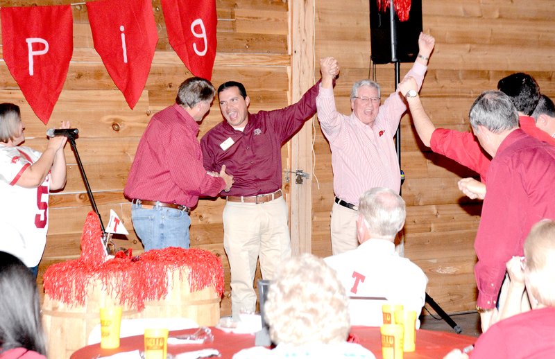 Jeff Della Rosa/Special to Siloam Sunday From left, Wenona Studards, Greg Walters, Randy Torres and Tommy Free call the Hogs at the Outstanding Civic Leadership Event at The Cypress Barn on Tuesday. Free, a big Arkansas Razorbacks fan, was roasted and toasted at the event.