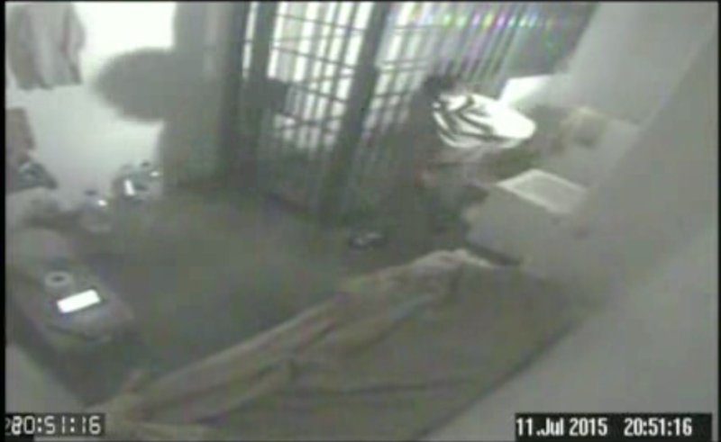 In this file screen grab of video from a security camera, dated July 11, 2015 and released by Mexico's National Security Commission, shows the man Mexican authorities say is Joaquin "El Chapo" Guzman, pacing inside his cell at the Altiplano maximum security prison, shortly before escaping through a tunnel below the shower area, top right, in Almoloya, Mexico. A new closed circuit prison video broadcast Wednesday, Oct. 14, 2015, by the Mexican television chain Televisa, reveals hammering sounds several minutes before the country's most notorious drug lord escaped from his cell through a tunnel. 