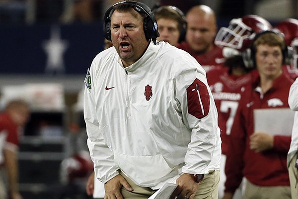 Arkansas coach Bret Bielema talks to his players during the second half of an NCAA college football game against Texas A&M on Saturday, Sept. 26, 2015, in Arlington, Texas. Texas A&M won in overtime, 28-21. (AP Photo/Tony Gutierrez)