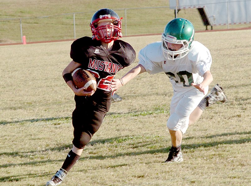 Photo by Rick Peck McDonald County seventh-grader Logan Renner eludes a Mount Vernon defender during the Mustangs&#8217; 28-14 loss Oct. 15 at MCHS.