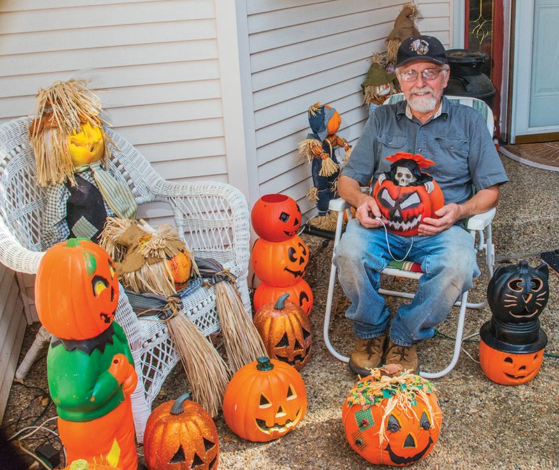 Jack Newman of Hot Springs Village sits with a few of the more than 330 jack-o’-lanterns he has collected for more than a decade. He started the collection when he lived in Illinois, and he displays the jack-o’-lanterns each year at his home on Del Camino Lane. Asked if the collection is an obsession, Newman laughed and said, “Maybe.”