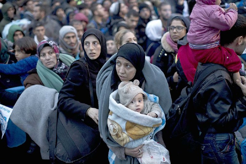 Migrants line up Thursday to pass through a police checkpoint in Bapska, Croatia, near the border with Serbia.