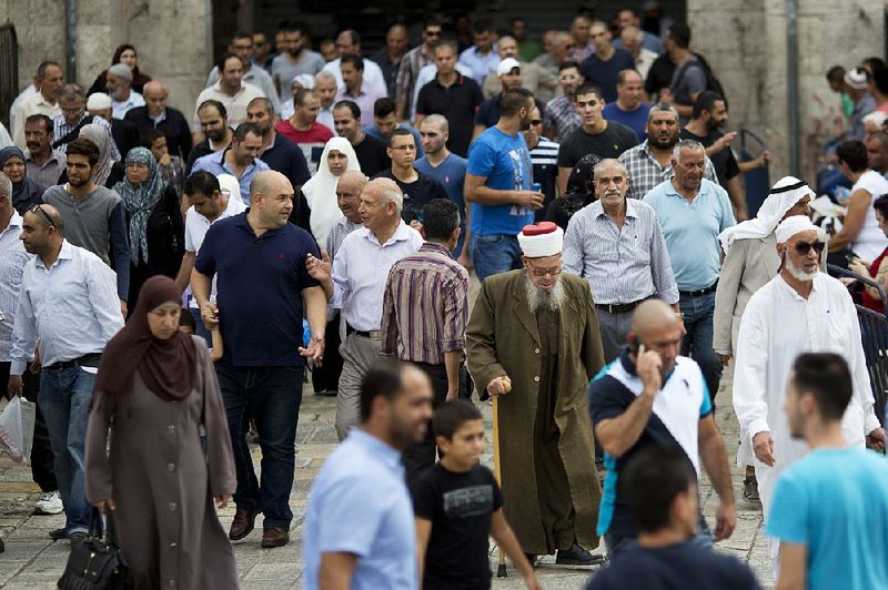 Palestinians walk through Jerusalem’s Old City after Israel allowed Friday prayers by Muslims of all ages at the shrine there that includes the Al-Aqsa and Dome of the Rock mosques.
