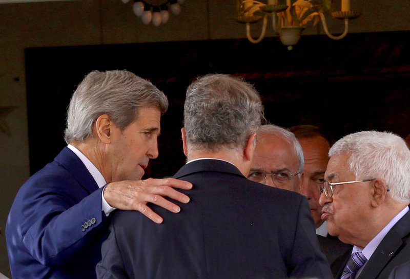 U.S. Secretary of State John Kerry, left, speaks with Palestinian President Mahmoud Abbas, right, after their meeting at Abbas' residence in Amman, Jordan, Saturday, Oct. 24, 2015. Kerry said Saturday that Israel and Jordan have agreed on steps aimed at reducing tensions at a holy site in Jerusalem that have fanned Israeli-Palestinian violence. "All the violence and the incitement to violence must stop. Leaders must lead," Kerry told reporters in the Jordanian capital after meeting with King Abdullah II and Abbas. 