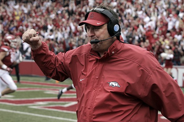 Arkansas' Bret Bielema celebrates after a touchdown during the fourth overtime of an NCAA college football game against Auburn, Saturday, Oct. 24, 2015, in Fayetteville, Ark. Arkansas won 54-46 in four overtimes. (AP Photo/Samantha Baker)