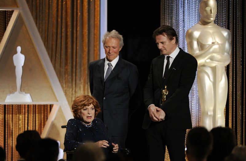 This Nov. 8, 2014 file photo actress Maureen O'Hara accepts her Honorary Oscar onstage as presenters Clint Eastwood, center, and Liam Neeson look on during the 2014 Governors Awards in Los Angeles. O'Hara,who appeared in such classic films as "The Quiet Man” and How Green Was My Valley," has died. Her manager says O’Hara died in her sleep Saturday, Oct. 24, 2015 at her home in Boise, Idaho.