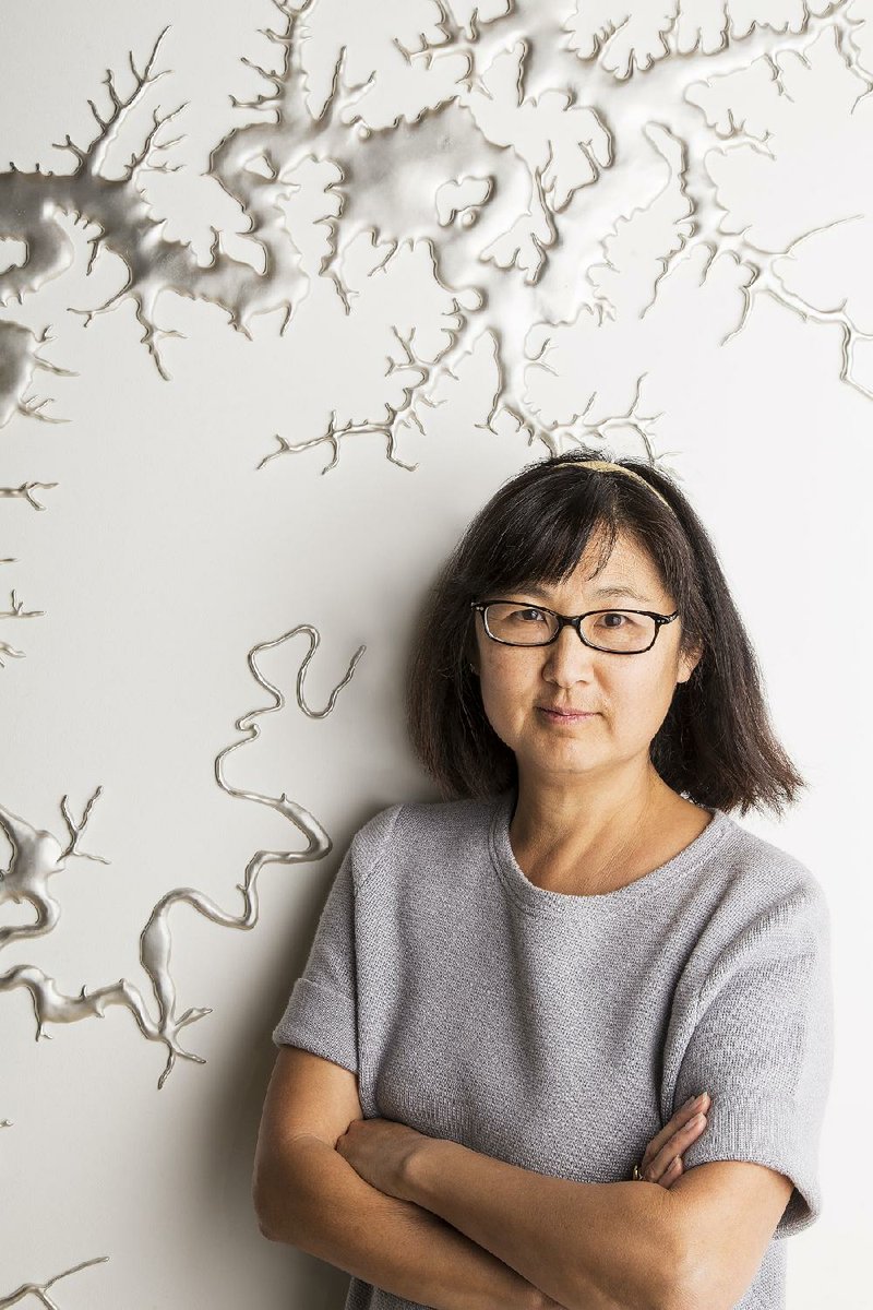 Artist Maya Lin, who designed the Vietnam Veterans Memorial in Washington, stands before her sculpture of the White River, which she became fascinated with after seeing it from the air, calling it “the wildest shape I had ever seen.”