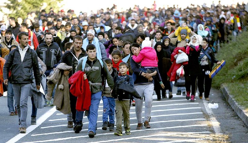 Migrants headed toward Austria leave a camp in Sentilj, Slovenia, on Saturday. Slovenian President Borut Pahor is demanding immediate action by the European Union as thousands of asylum seekers pour into his country.