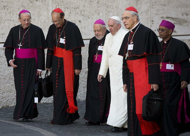 Pope Francis arrives at the Vatican alongside bishops and cardinals Saturday, the last day of the synod of bishops.