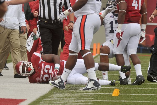 Arkansas running back Rawleigh Williams III is injured after being tackled by Auburn defender Kris Frost in the third quarter of the Razorbacks' 54-46 four overtime win over Auburn on Saturday, Oct. 24, 2015, at Razorback Stadium in Fayetteville.