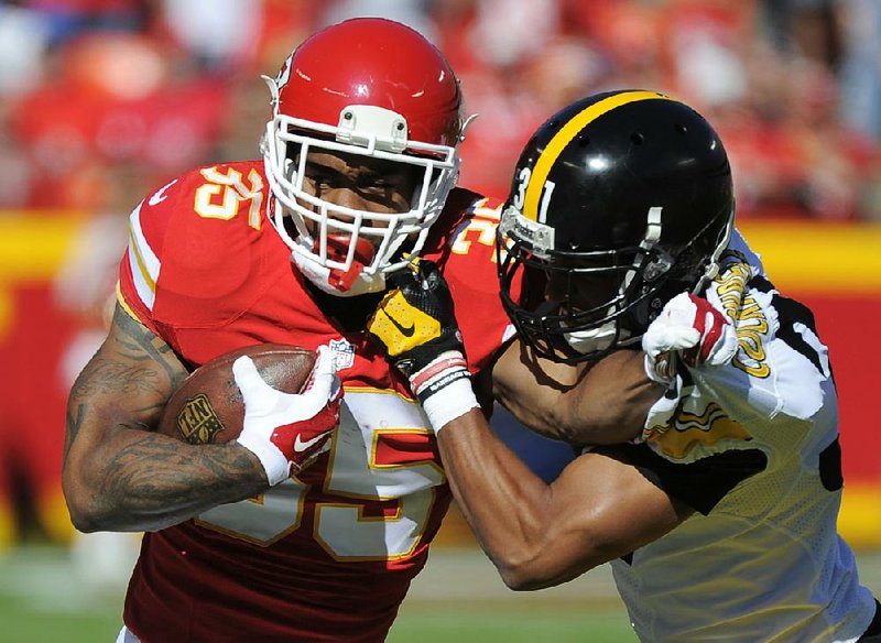 Kansas City Chiefs running back Charcandrick West (35) tries to get past Pittsburgh Steelers defensive back Ross Cockrell during the first half of Sunday’s game in Kansas City, Mo.
