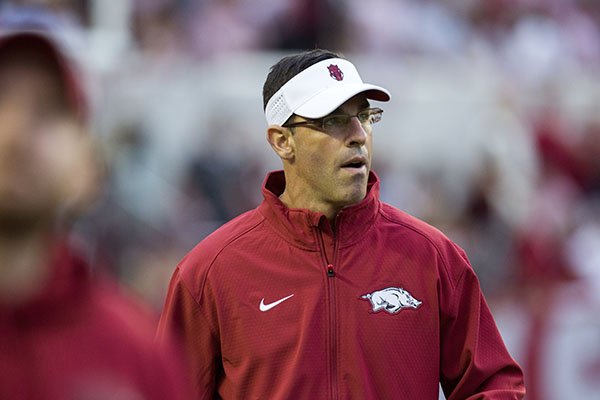 Arkansas offensive coordinator Dan Enos watches warmups prior to a game against Alabama on Saturday, Oct. 10, 2015, at Bryant-Denny Stadium in Tuscaloosa, Ala. 