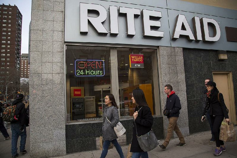 Pedestrians pass a Rite Aid Corp. store in New York in April. Walgreens Boots Alliance Inc. announced Tuesday that it has reached a deal for Rite Aid. 