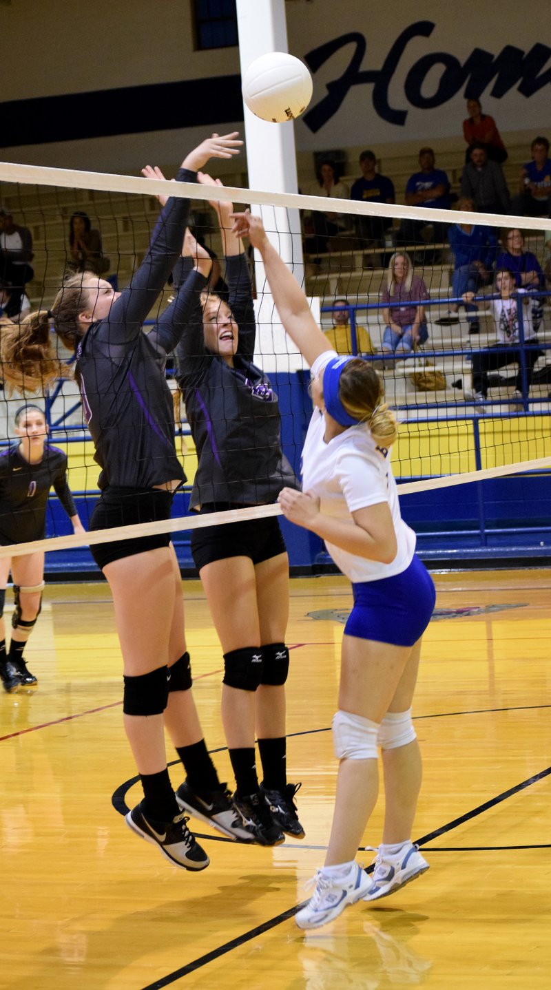 Photo by Mike Eckels Decatur&#8217;s Saidie Moydell (right) returns the Volleyball over the net as two Elkins players try for a block and return during the Bulldogs-Elks senior varsity volleyball match at Peterson Gym in Decatur Oct. 19. Elkins took the match, 3 sets to 1, handing Decatur its sixth lose of the season.