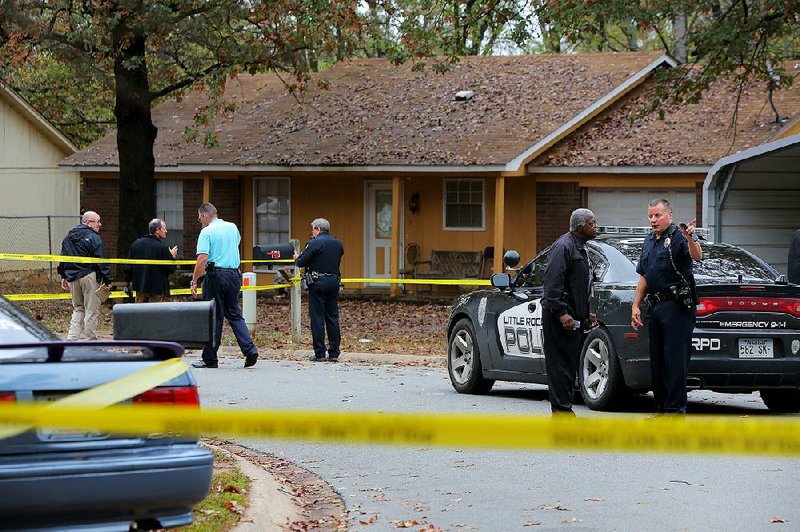 Little Rock police investigate outside a home at 25 Applegate Court on Wednesday where an officer responding to a burglary call fired his gun at a person seen running away. 