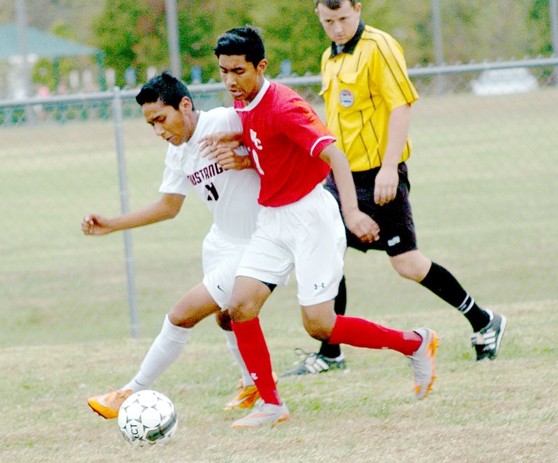 Photo by Rick Peck McDonald County&#x2019;s Alfredo Sanchez battles a Webb City defender for control of the ball during the Mustangs 1-0 win Oct. 22 at Crowder College.