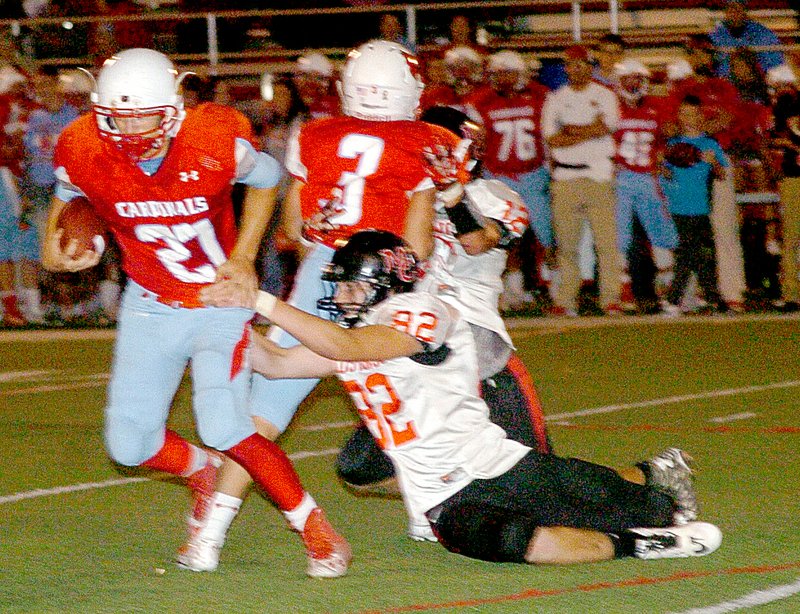 Photo by Rick Peck McDonald County defensive end Jon Blevins tackles Webb City&#x2019;s Cameron Baker for a short loss during the Cardinals 42-13 win Friday night.