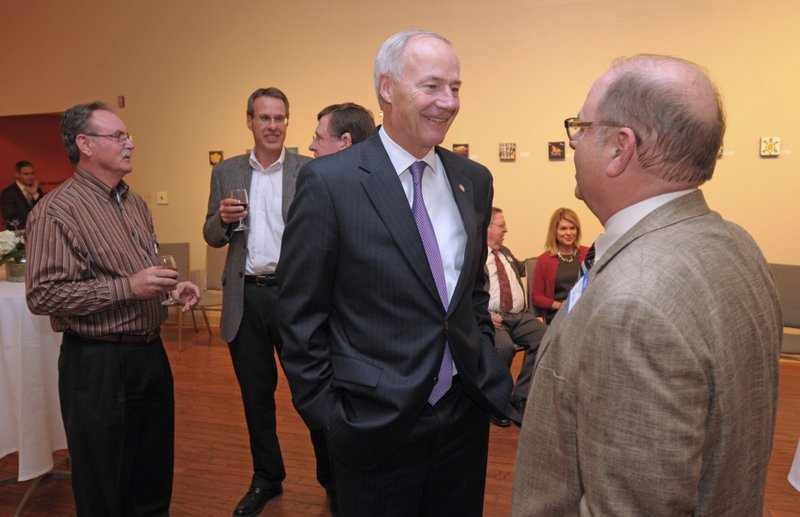 Gov. Asa Hutchinson (center) speaks with Philip Taldo of Springdale on Thursday before the start of the Springdale Public Schools Education Foundation Cornerstone Society induction ceremony at the Arts Center of the Ozarks in Springdale. Hutchinson was honored during the ceremony as a member of the Class of 1968. Visit nwadg.com/photos to see more photographs from the evening.

