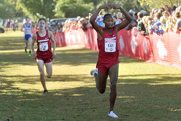 Arkansas' Frankline Tonui crosses the finish line ahead of teammate Christian Heymsfield during the Chile Pepper Festival on Saturday, Oct. 3, 2015, in Fayetteville. 