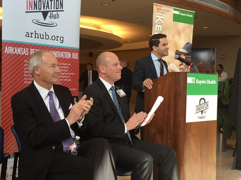 Gov. Asa Hutchinson (from left), Baptist Health President and CEO Troy Wells and Arkansas Regional Innovation Hub Executive Director Warwick Sabin on Friday, Oct. 30, 2015, introduce HubX, a 13-week program to boost up to 10 startup companies in the health care sector.