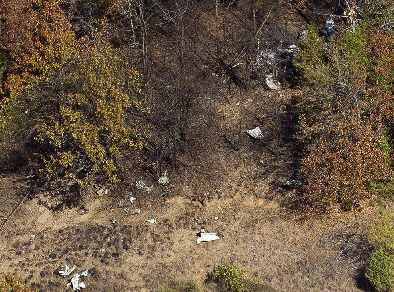 The burnt wreckage of a single-engine airplane lays among the trees on Crow Mountain in Russellville. 