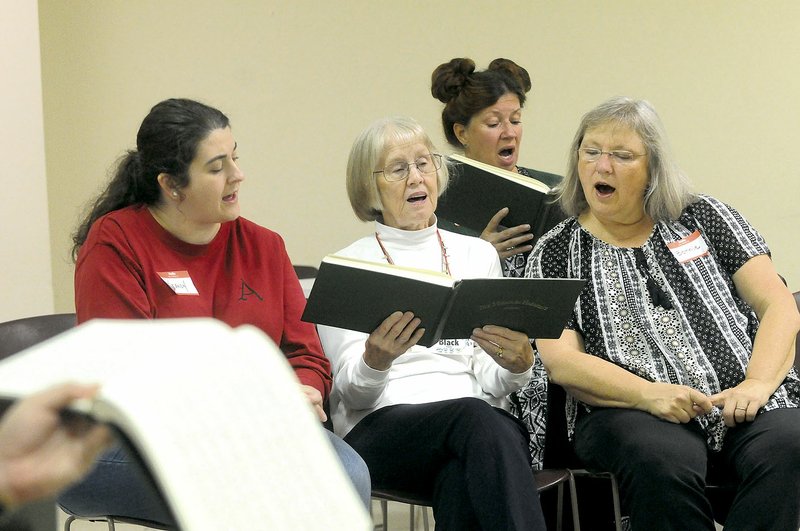 Sacred Harp singers Brandy Siler (from left), Katy Black, Bonnie Wood and Bonnie Whitbeck sing Oct. 24 during the Sacred Harp Singing Convention in Springdale. Sacred Harp singing is a method of traditional, easy-to-use shape notes, probably brought to the Ozarks by early settlers.