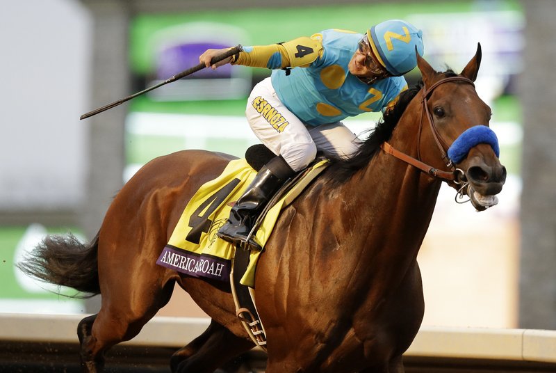 American Pharoah, with Victor Espinoza up, wins the Breeders' Cup Classic horse race at Keeneland race track Saturday, Oct. 31, 2015, in Lexington, Ky. 