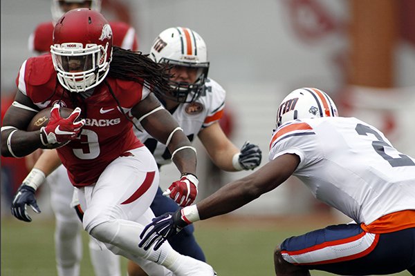 Arkansas' Alex Collins (3) dodges Tennessee-Martin's Terrious Triplett (2) during the first half of an NCAA college football game Saturday, Oct. 31, 2015, in Fayetteville, Ark. (AP Photo/Samantha Baker)
