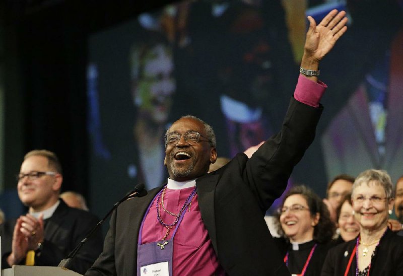 Bishop Michael Curry of North Carolina waves to the crowd at the Episcopal General Convention in Salt Lake City in June after he was elected the Episcopal Church’s first black presiding bishop. 