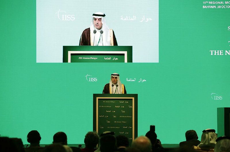 Saudi Arabian Foreign Minister Adel al-Jubeir addresses delegates Saturday at an international conference in Manama, Bahrain. He said ending the Syrian civil war will depend on the timing of Syrian President Bashar Assad’s departure and and the withdrawal of foreign fighters from the country. 