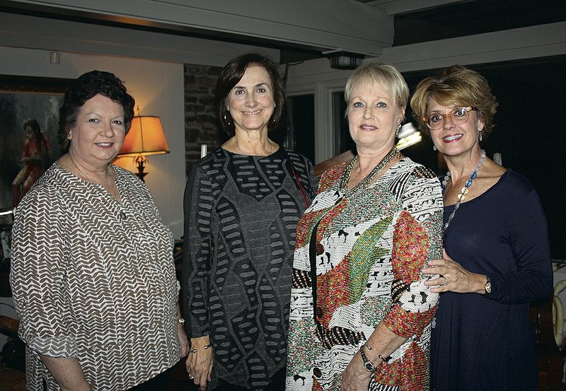 Jan Gierenger (from left), Beverly Harrison, member-at-large, Martha Haguewood, president and Melissa Hawkins, president-elect of the University of Arkansas Women's Giving Circle stand for a photo Oct. 22 at a reception for the group at the home of Denise and Hershey Garner in Fayetteville.