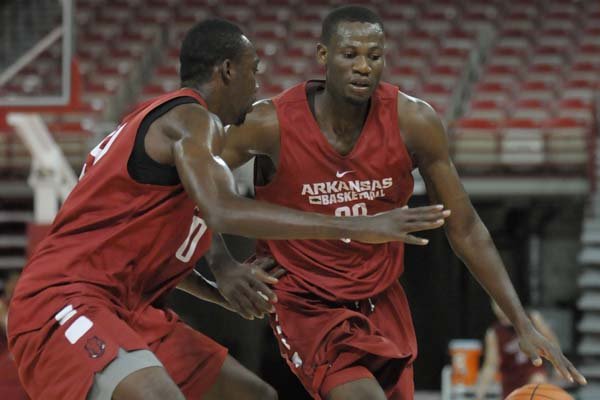 Moses Kingsley (right) and Willy Kouassi (left) of Arkansas participate in a drill Saturday, Oct. 24, 2015, during practice in Bud Walton Arena. Arkansas opened practice to the public before the football Razorbacks' game with Auburn.