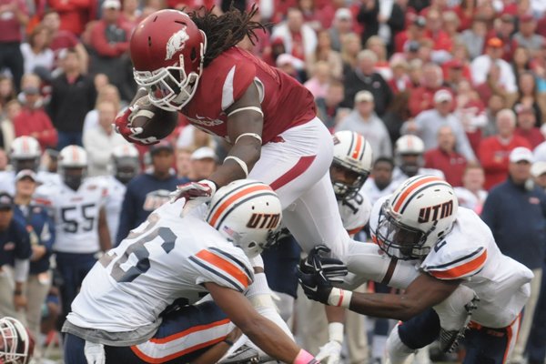 Alex Collins (top) of Arkansas leaps over Walter Evans (26) and Terrious Triplett (2) of UT-Martin Saturday, Oct. 31, 2015, during the second quarter at Razorback Stadium in Fayetteville.